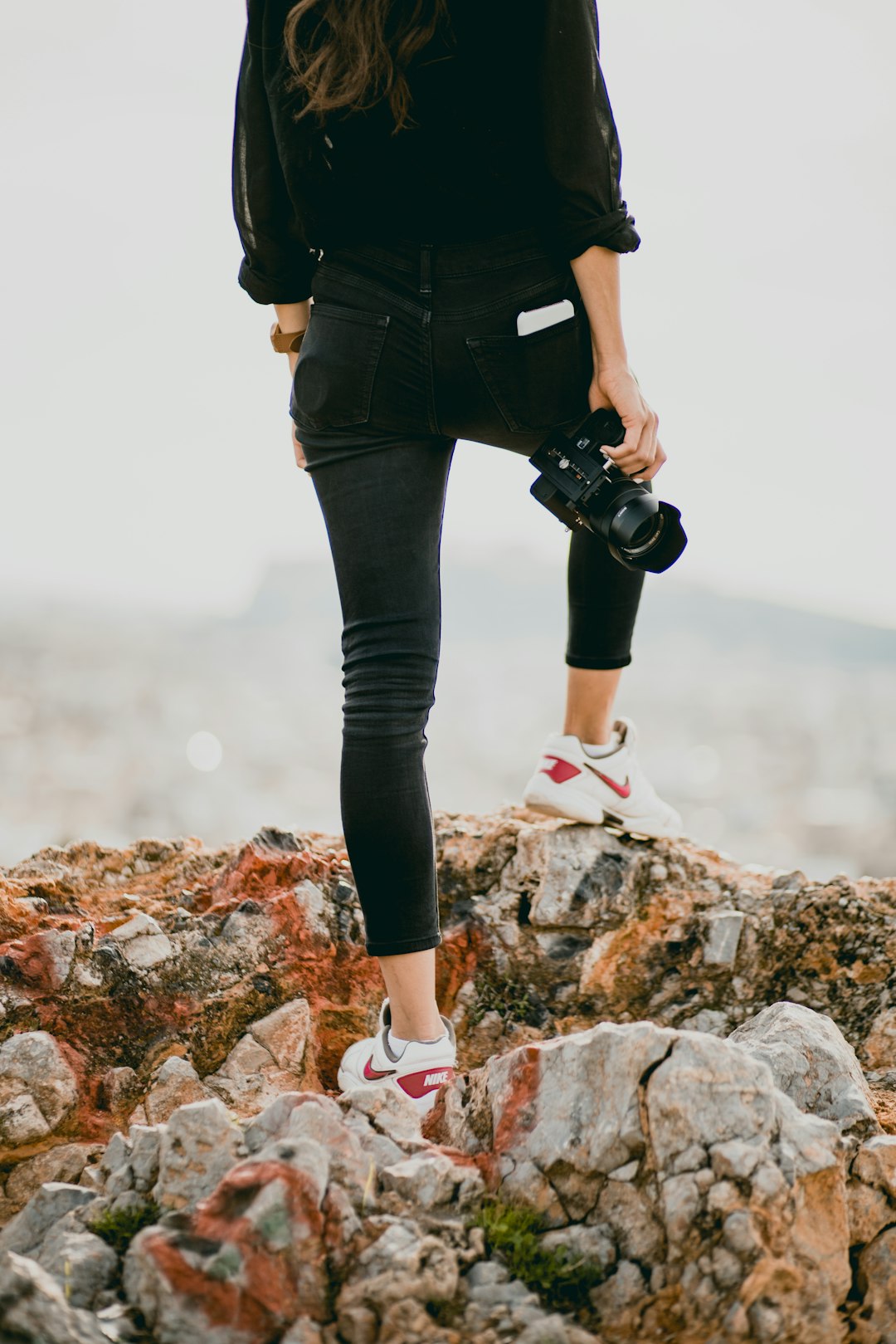 woman-in-black-shirt-and-black-pants-holding-black-dslr-camera-yc1-ifucez4